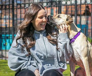 A person smiling next to a dog